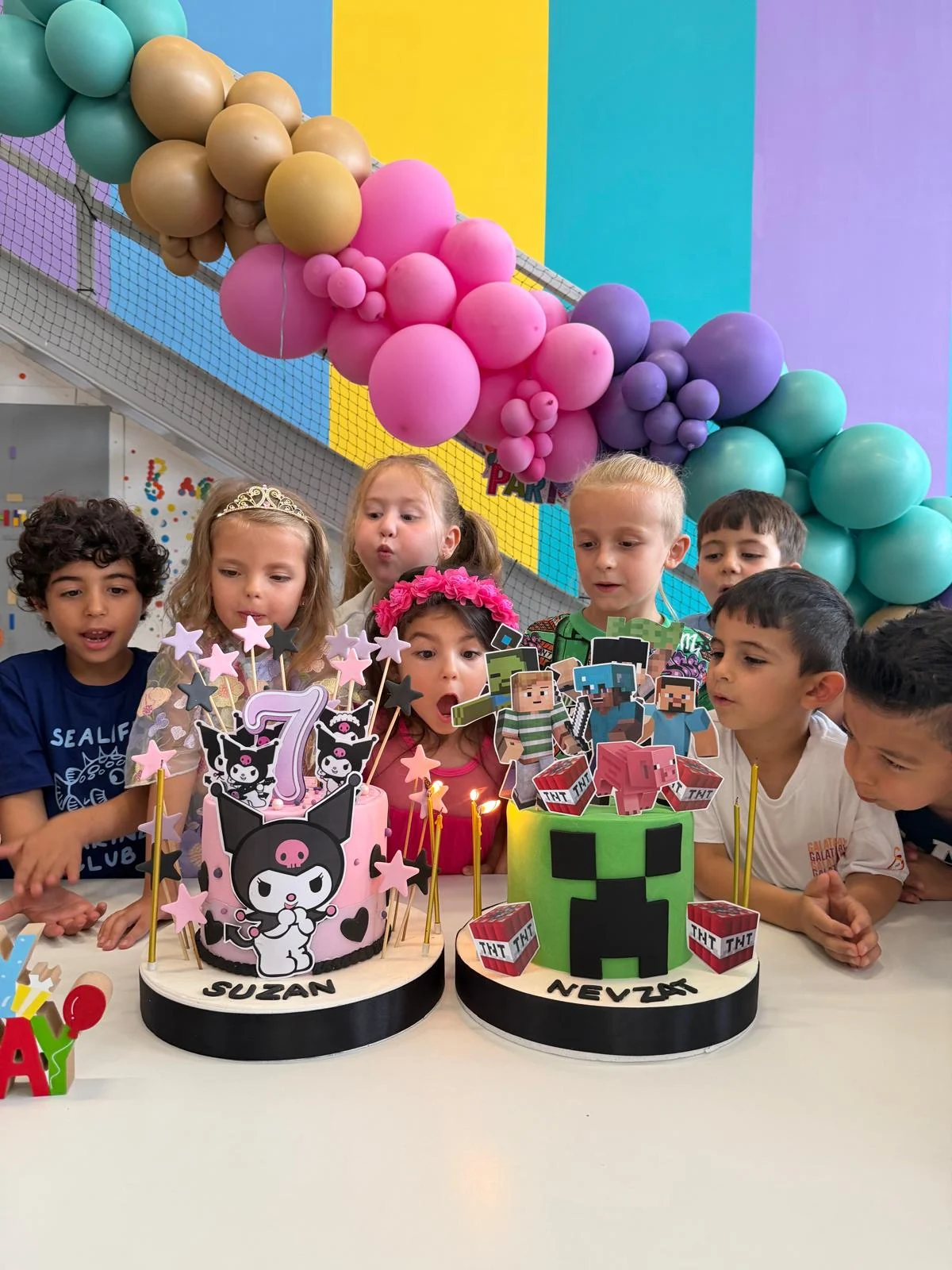 Children blowing out candles on birthday cakes