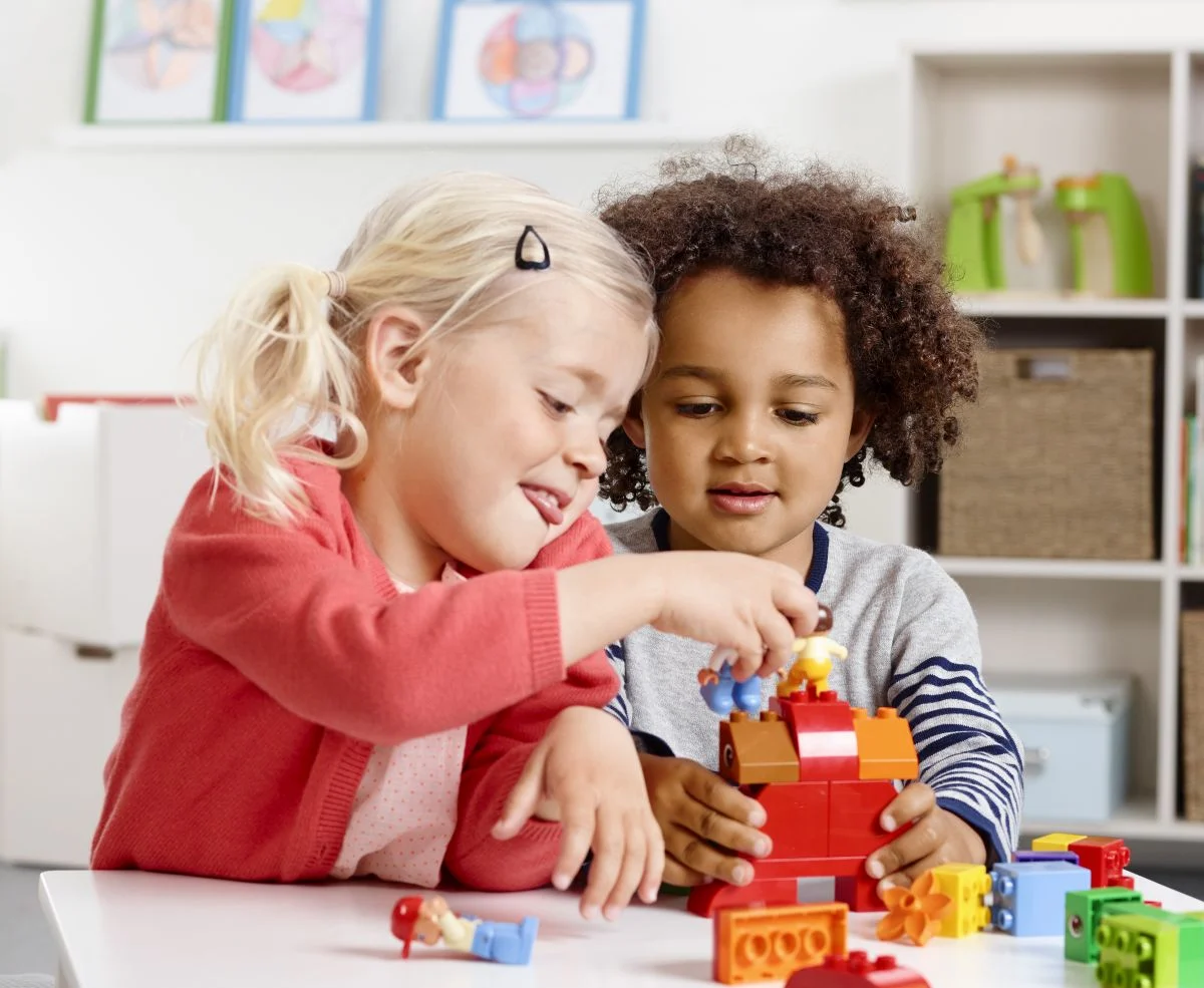 Children exploring creative learning materials